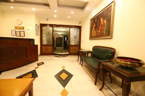 a living room with a couch and a table at Hotel Ambica Palace AIIMS New Delhi - Couple Friendly Local ID Accepted in New Delhi