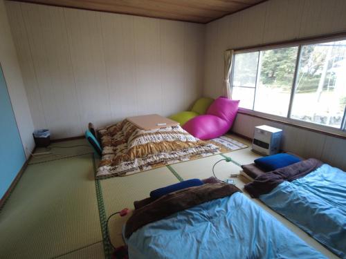 Habitación pequeña con 2 camas y ventana en Asobigokoro - Vacation STAY 03618v, en Aso