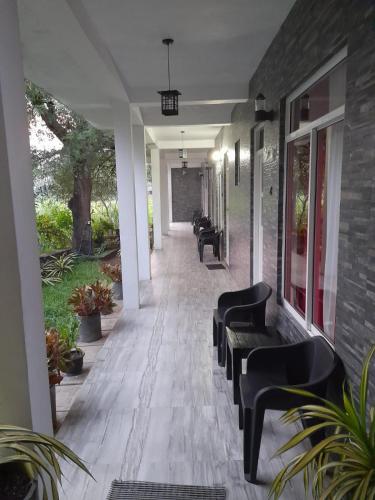 a row of benches on a walkway with a building at My Home Guest in Polonnaruwa