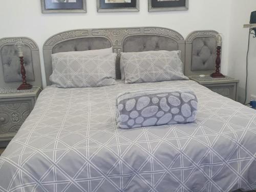 a bed with two pillows on top of it at Lieflappie❤ in Stilbaai