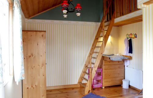 a room with a wooden staircase in a room at Schwedentraum Varpstugan in Kisa