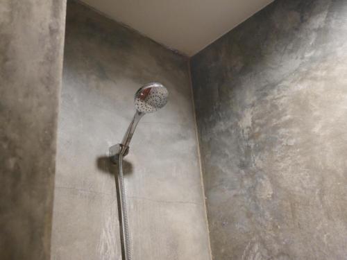 a shower head in a corner of a room at Andaman Resort in Phi Phi Don