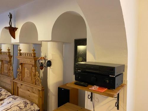 a bedroom with a bed and a television on a table at Penzio Ostrava in Ostrava