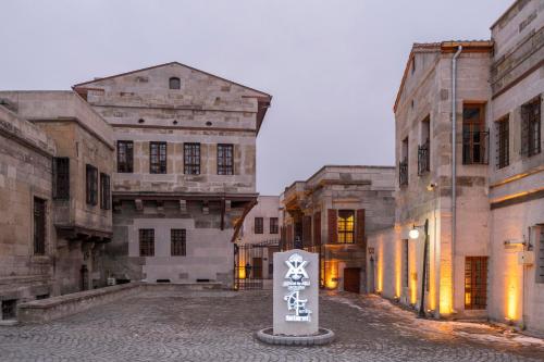 a sign in the middle of a group of buildings at Kerem ile Aslı Butik Hotel in Melikgazi