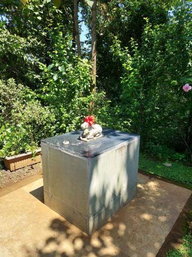 a statue of a dog sitting on top of a box at Destination A1 32 Villa in Neral