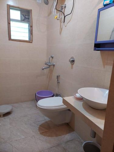 a bathroom with a toilet and a sink at Destination A1 32 Villa in Neral