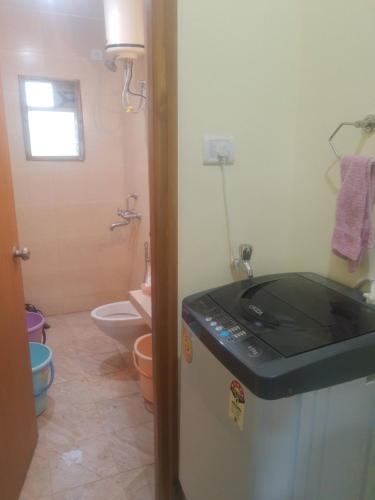a small bathroom with a sink and a refrigerator at Destination A1 32 Villa in Neral