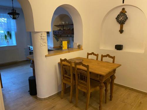 a kitchen and dining room with a wooden table and chairs at Penzio Ostrava in Ostrava