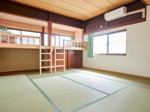a room with two bunk beds and a window at Hanareya in Tsushima