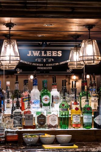 a bar with a lot of bottles of alcohol at The Stanneylands in Wilmslow
