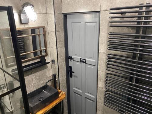 a bathroom with a white door and a mirror at Penzio Ostrava in Ostrava