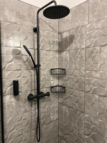 a shower with two baskets on the wall at Penzio Ostrava in Ostrava