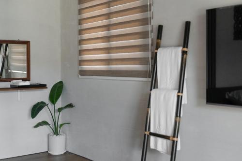 Una escalera de toallas en una habitación con ventana en Bali Slow Homestay, en Dongshan