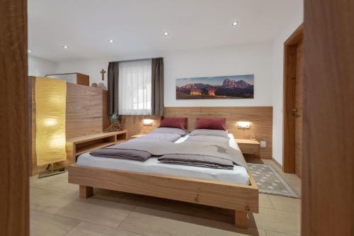 a bedroom with a large bed in a room at Apartment Cësa Zinch in Ortisei