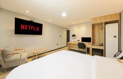 a hotel room with a netflix sign on the wall at LABE Hotel in Jeonju