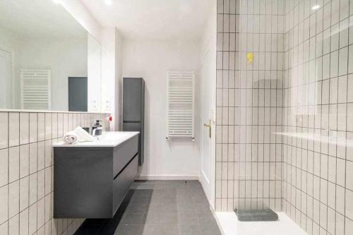 a white bathroom with a sink and a shower at New top floor apt with a lot of light y aircon in Girona