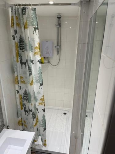 a bathroom with a shower curtain with deer on it at Deer Lodge in Thornton Curtis