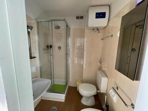 a bathroom with a shower and a toilet and a sink at La Ricciola - Eurotel 523 in Rapallo