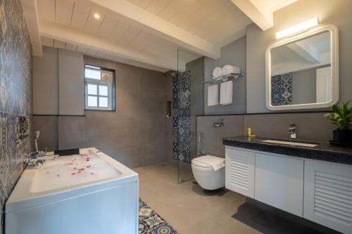 a bathroom with a sink and a toilet at O Pierre in Panaji