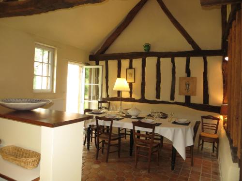 a dining room with a table and chairs at La Ferme de Montboulan in Salbris