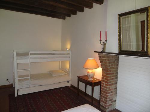 a bedroom with a bunk bed and a mirror at La Ferme de Montboulan in Salbris