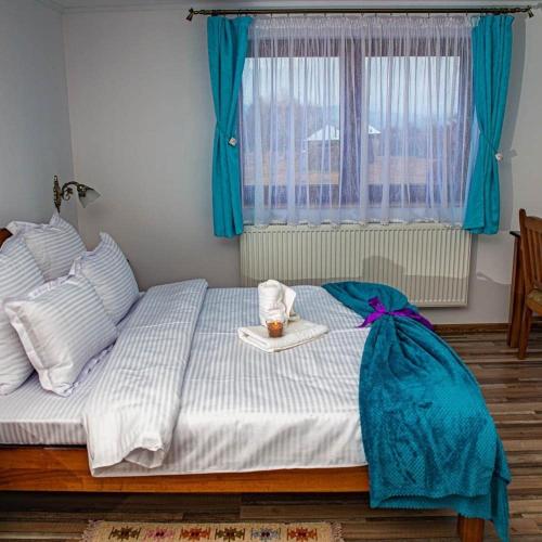a bedroom with a bed with a tray of food on it at Casa OLD BRICK in Ocna Şugatag
