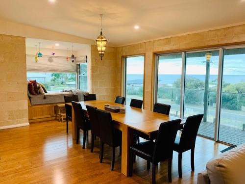 a dining room with a table and chairs at Emu Bay Bliss 'sweeping ocean views' in Emu Bay