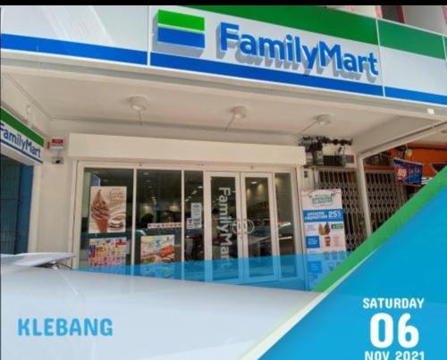 a gas station with a sign on the front of it at CosY Klebang Homestay in Kampong Lereh