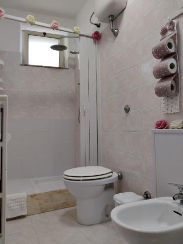 a bathroom with a toilet and a shower and a sink at B&B Planet in Montalbano Jonico