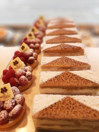 a row of breads and berries on a table at The Originals Boutique, Hôtel d'Alsace, Strasbourg Sud in Illkirch-Graffenstaden