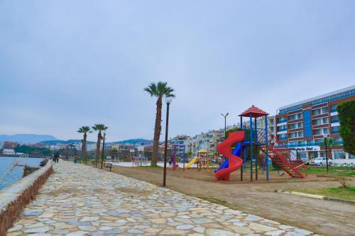 a playground with a slide and a slidesktopktopktopktopktopktopktopktop at Perla Hotel in Dikili