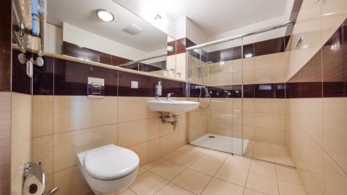 a bathroom with a toilet and a sink at Olympic Park I, Sun & Snow in Kołobrzeg