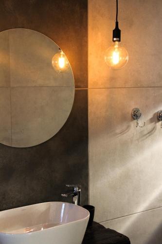 a bathroom with a white sink and a mirror at bird haven self catering in Donny-brook