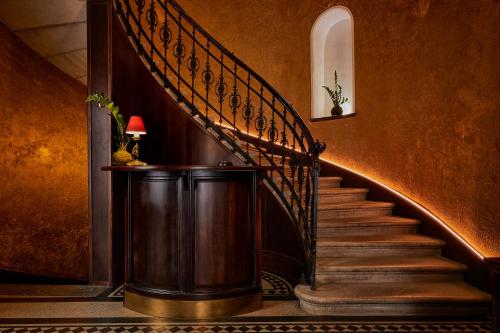 
a stairway leading up to a staircase with a fire hydrant at Gerlóczy Boutique Hotel in Budapest
