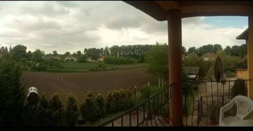 a view of a field from the balcony of a house at Vencsellői Wellness Vendégház in Gávavencsellő