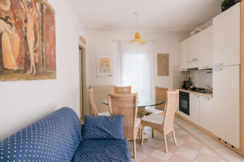 a living room with a blue couch and a table at Villa Carlotta Jesolo Lido in Lido di Jesolo
