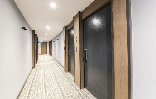 a corridor of a hallway with doors and a long aisle at LABE Hotel in Jeonju