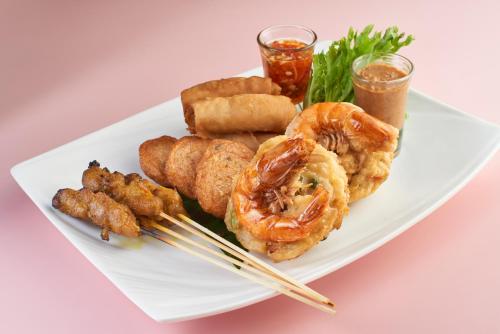 a plate of food with shrimp and other food items at Park Inn by Radisson Putrajaya in Putrajaya
