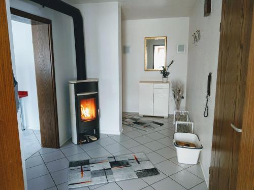 a living room with a wood stove in a room at Ferienwohnung Monika Scholtz in Königheim