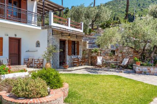 a house with a patio and a yard at Irida Apartments in Stafylos
