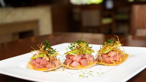 three sandwiches with ham and vegetables on a white plate at Hyatt Regency Villahermosa in Villahermosa