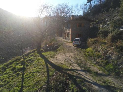 a car parked next to a house on a dirt road at Rifugio del Granasco in Stella
