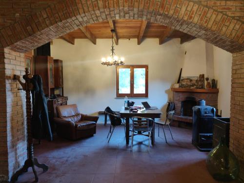 a living room with a table and a fireplace at Rifugio del Granasco in Stella