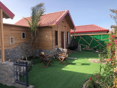 a patio with chairs and a house at استراحة ريف حتا in Hatta