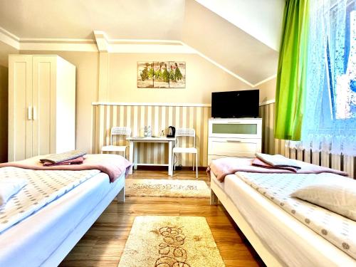 Кровать или кровати в номере Ziołowa Dolina