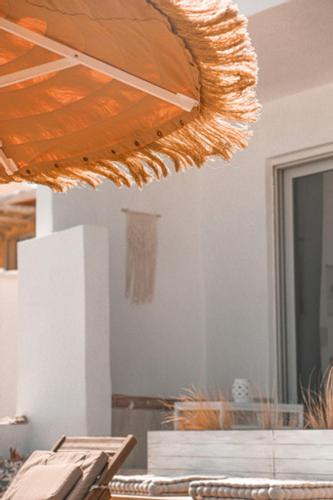 a close up of a table with an umbrella at Esperanto seafront studio in Agia Marina Nea Kydonias