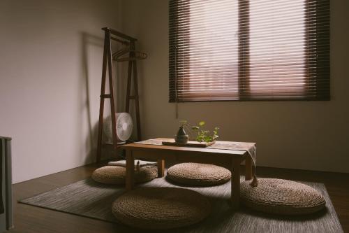 a living room with a table and two stools at Shu Sia in Hengchun