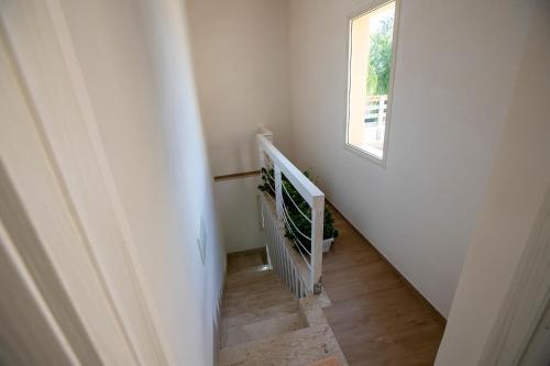 a stairway with a white railing and a window at Romeo&giuliet in Marsala