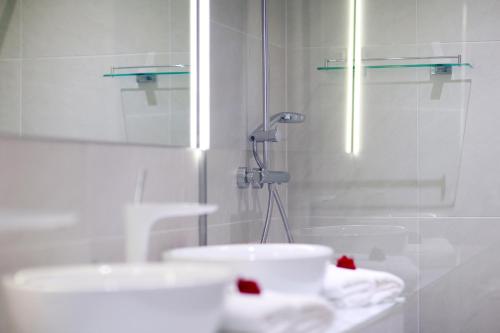 a bathroom with a glass shower and a sink at Hotel 9 in Zagreb