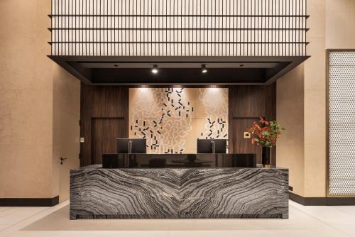 a lobby with a reception desk in a building at Eurostars Ambassador in Budapest